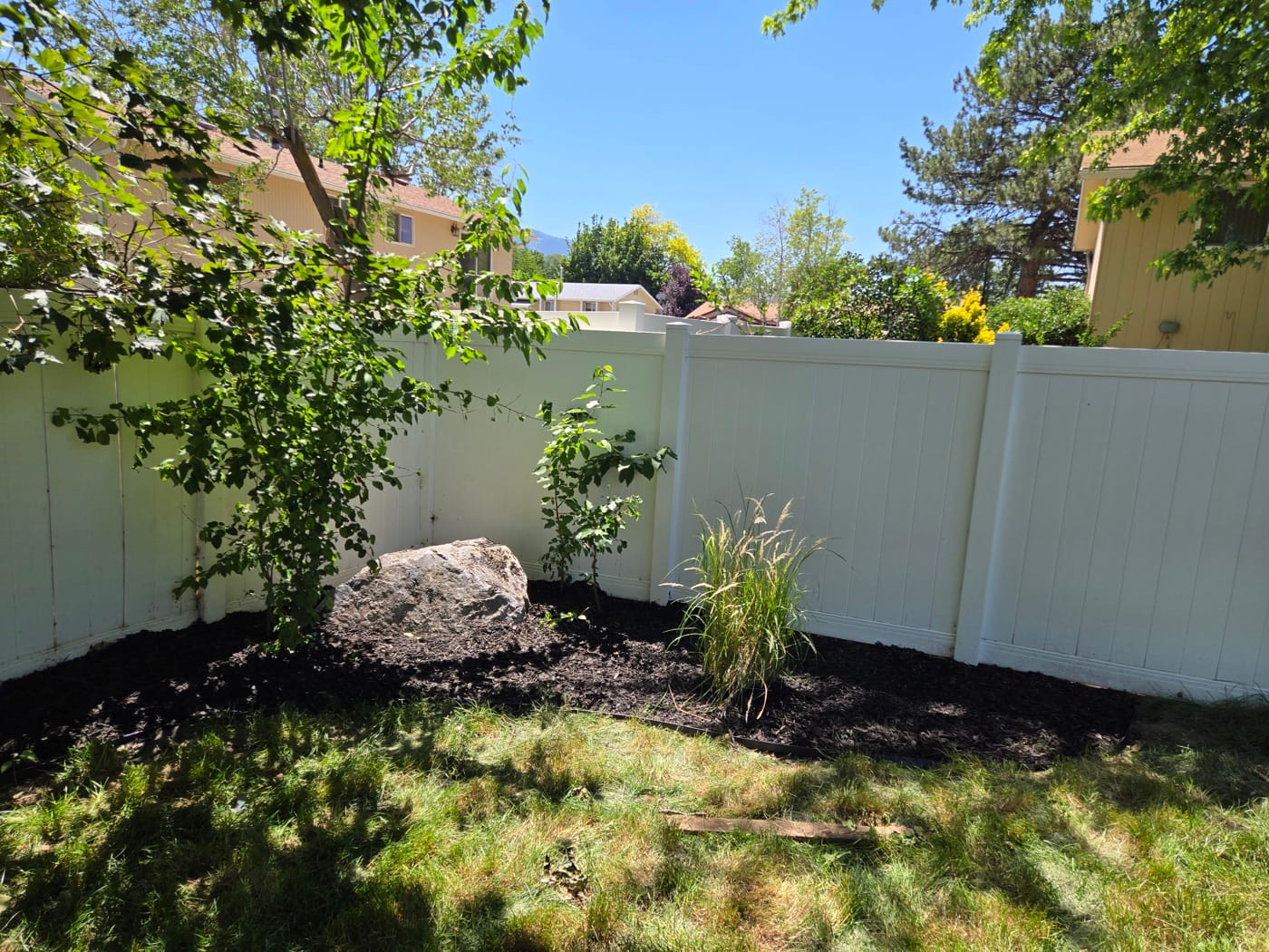 Fresh mulch and trimmed landscaping beds by MK HomePro — spring maintenance checklist for Salt Lake Valley UT